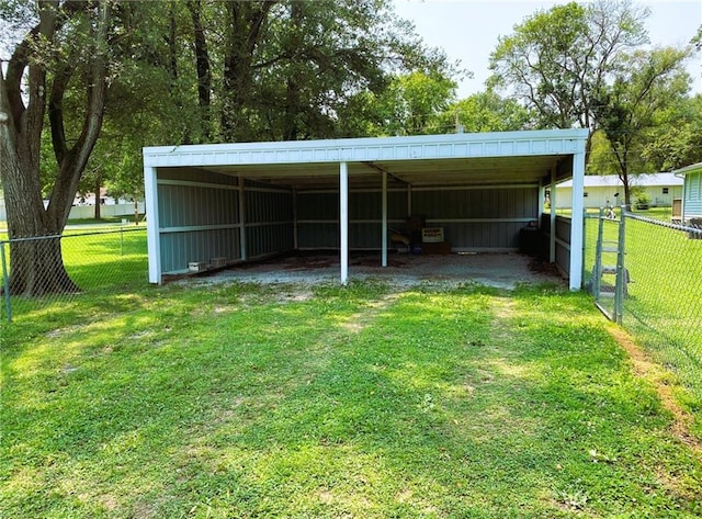 view of parking / parking lot with an outbuilding, driveway, a detached carport, and fence