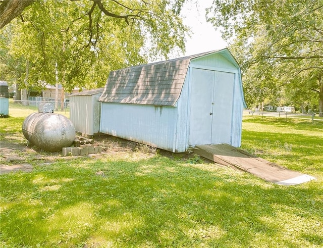 view of shed featuring fence