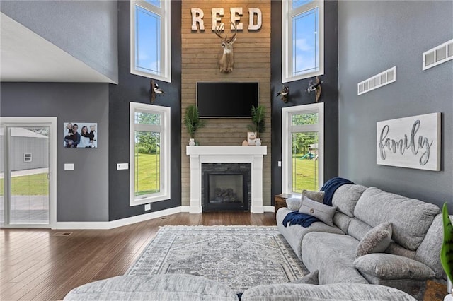 living room featuring dark hardwood / wood-style flooring and a high ceiling