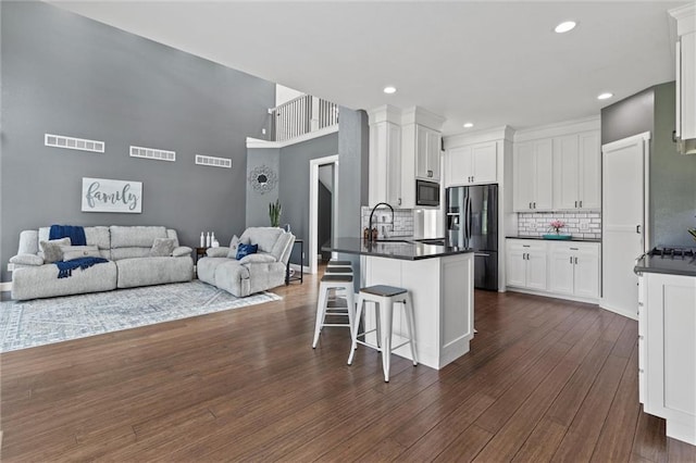 kitchen featuring white cabinetry, dark hardwood / wood-style floors, and stainless steel appliances