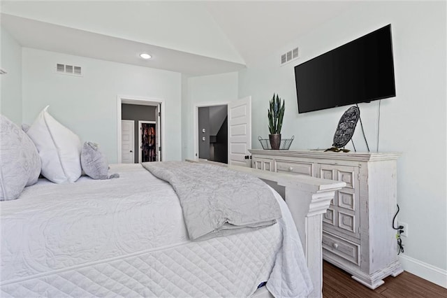 bedroom featuring dark hardwood / wood-style flooring and lofted ceiling