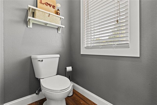 bathroom featuring hardwood / wood-style flooring and toilet