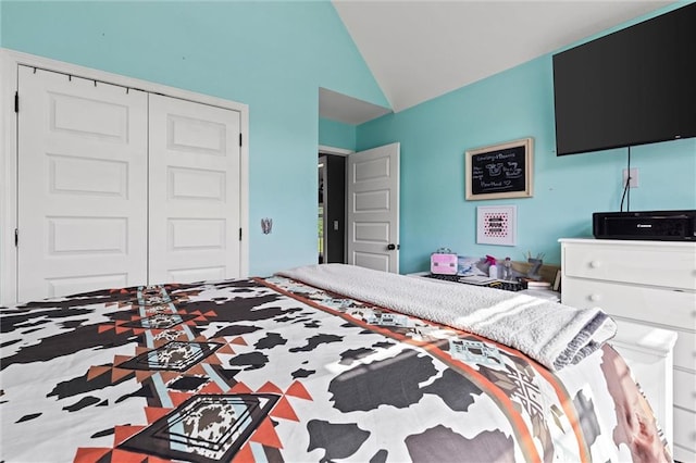 bedroom featuring high vaulted ceiling and a closet