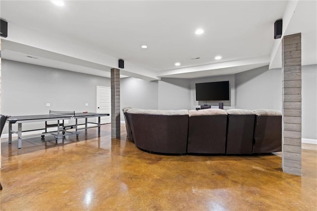 living room with concrete floors and ornate columns