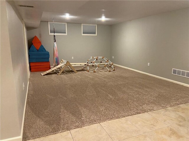 recreation room with carpet floors, visible vents, and baseboards