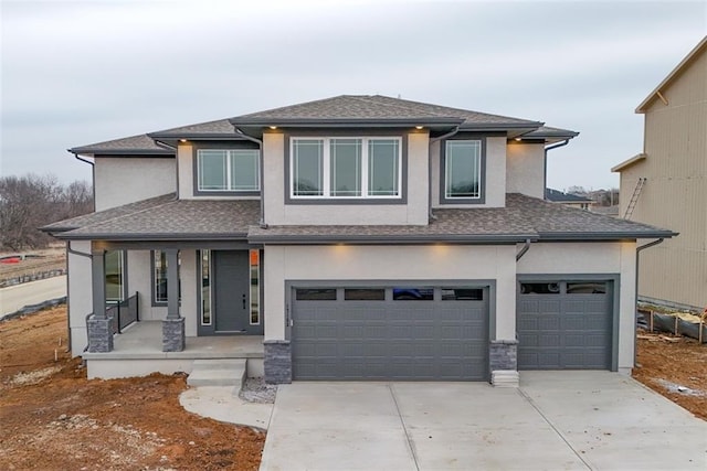 prairie-style home with a garage and covered porch