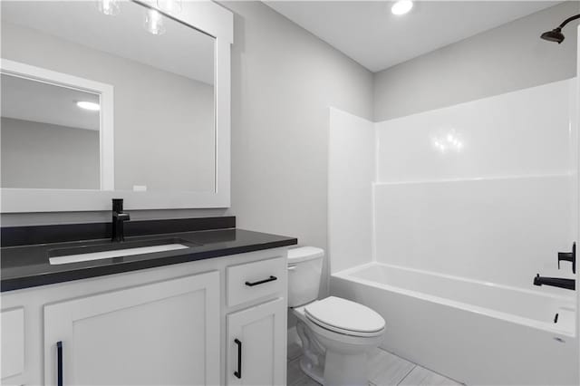 full bathroom with vanity, bathtub / shower combination, and toilet