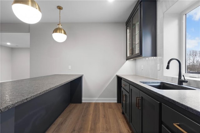 kitchen with sink, pendant lighting, and dark hardwood / wood-style floors