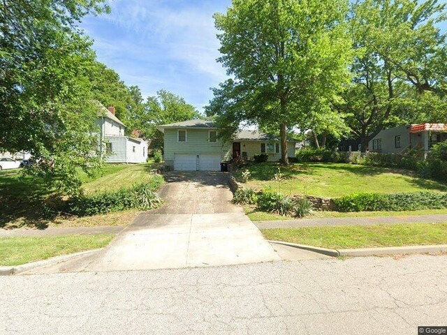 view of front of house with a garage and a front lawn