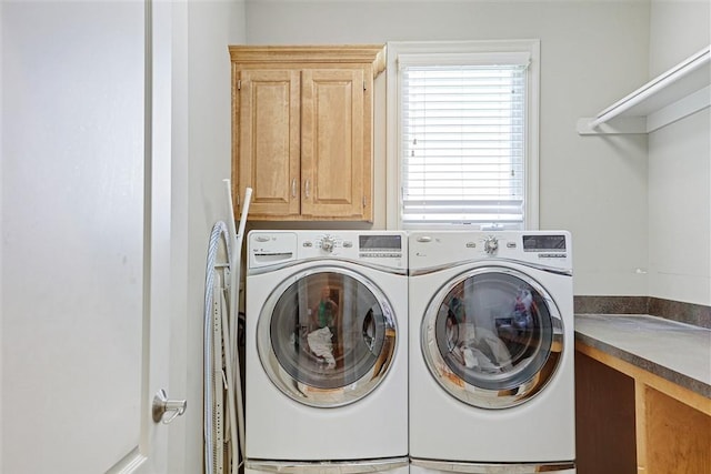 laundry area with cabinets and washer and dryer