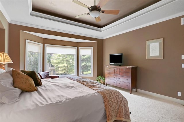 carpeted bedroom with crown molding, a raised ceiling, and ceiling fan