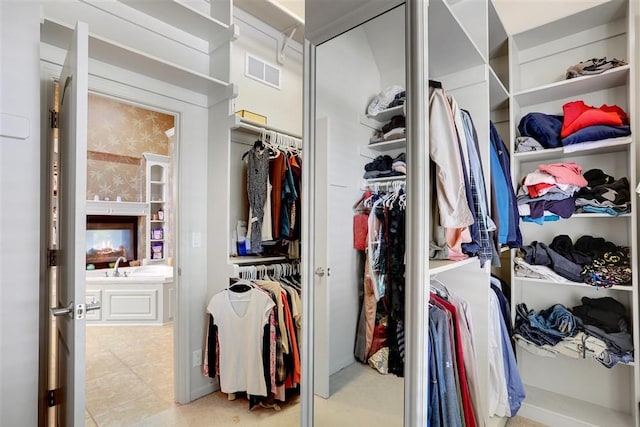 spacious closet with light tile patterned floors