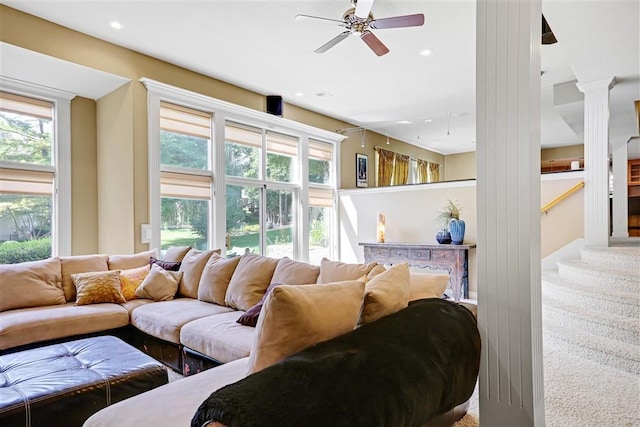 living room featuring plenty of natural light, carpet flooring, and ceiling fan