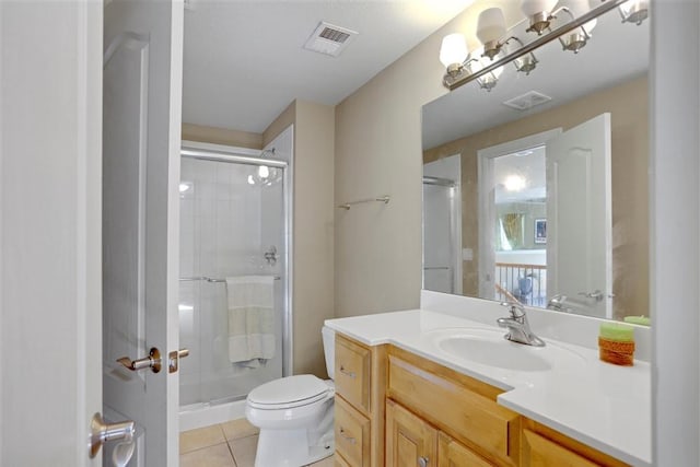 bathroom with vanity, toilet, an enclosed shower, and tile patterned flooring