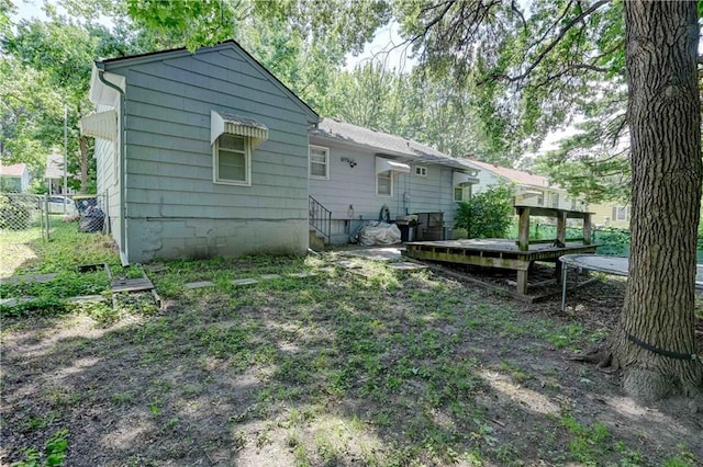 rear view of house featuring a deck