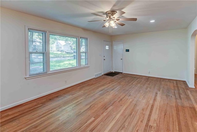 spare room with wood-type flooring and ceiling fan