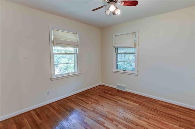 empty room featuring light wood-type flooring and ceiling fan