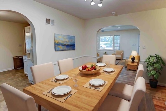 dining room with wood-type flooring