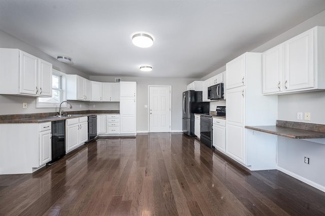 kitchen with dark hardwood / wood-style flooring, white cabinets, and black appliances