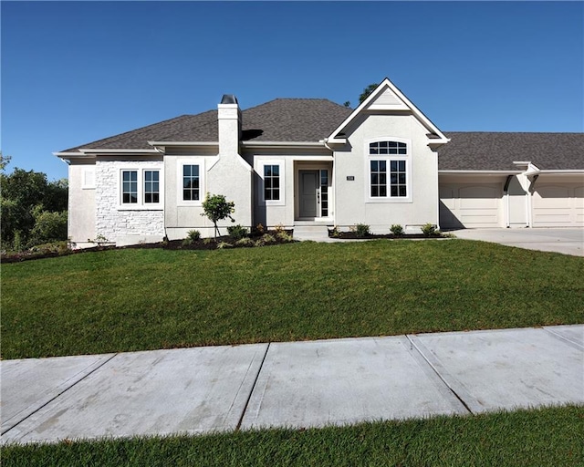 view of front of home with a garage and a front lawn