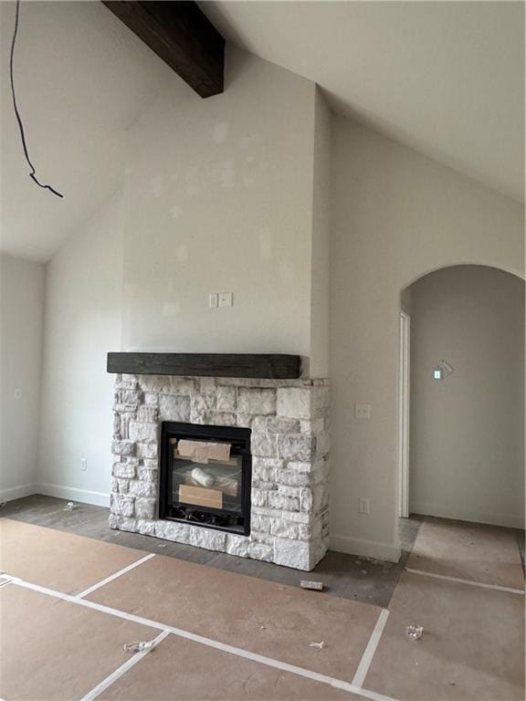 unfurnished living room featuring high vaulted ceiling, a fireplace, and arched walkways