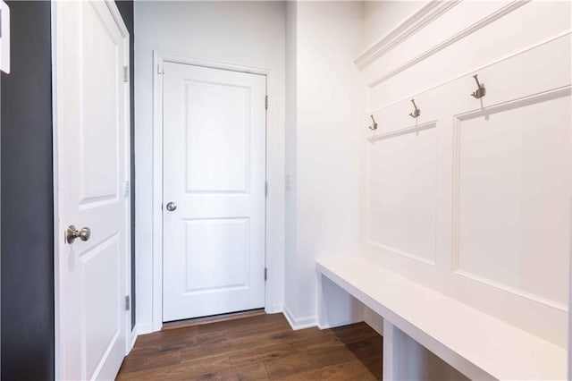 mudroom with dark wood-style flooring and baseboards