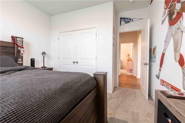bedroom featuring light carpet and a closet