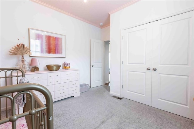 bedroom with visible vents, light colored carpet, baseboards, a closet, and ornamental molding