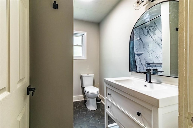 bathroom with tile patterned flooring, vanity, and toilet