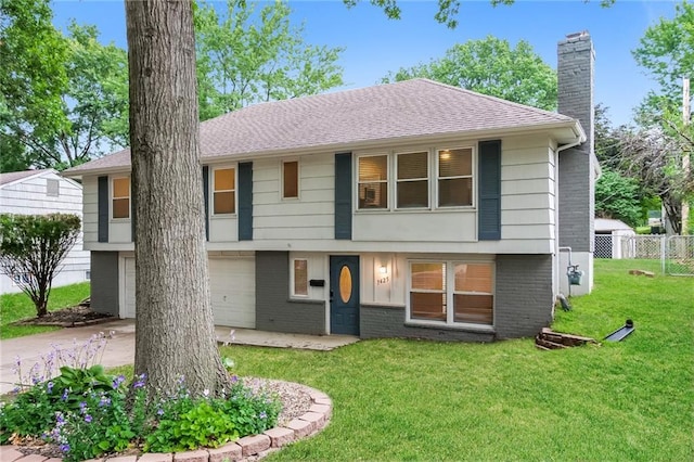 view of front of property with a front yard and a garage