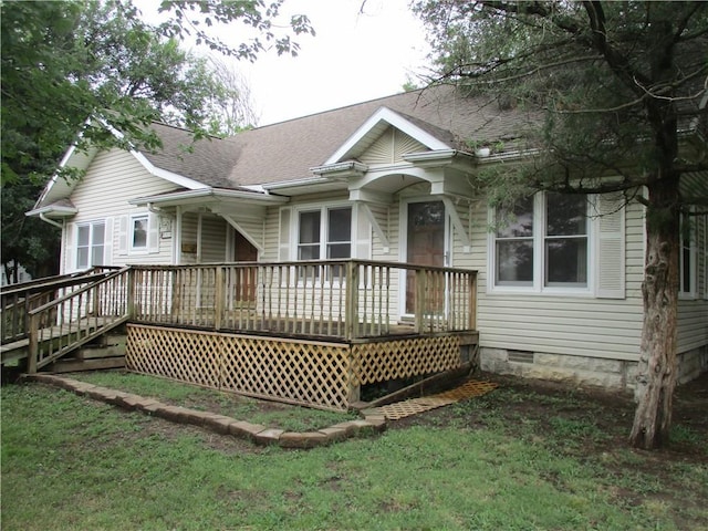 rear view of property with a lawn and a deck