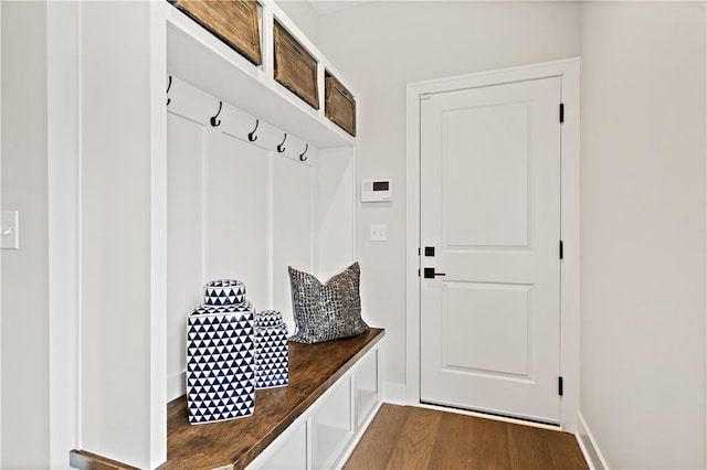 mudroom featuring baseboards and wood finished floors