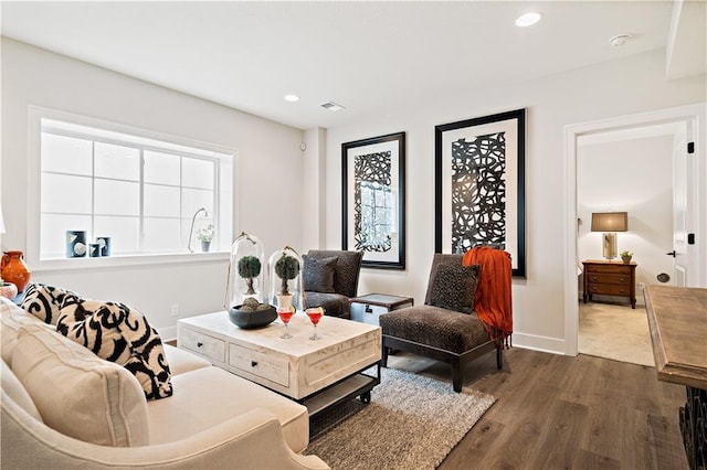 living room with dark wood-style floors, recessed lighting, visible vents, and baseboards