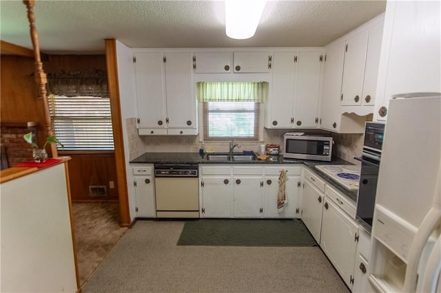 kitchen featuring sink, tasteful backsplash, a textured ceiling, white appliances, and white cabinets