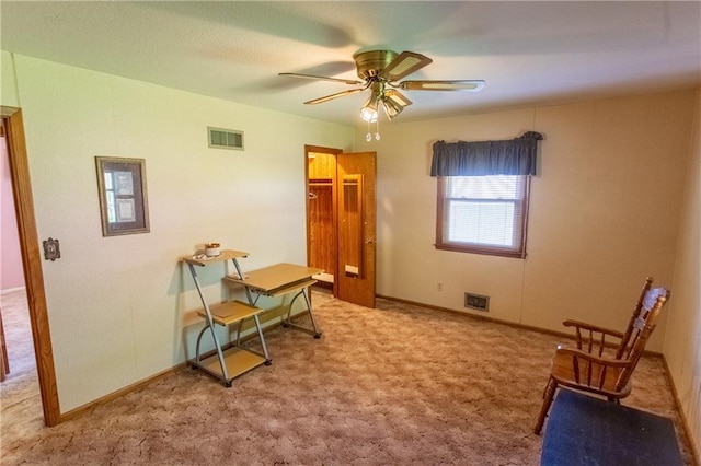 living area with carpet flooring and ceiling fan