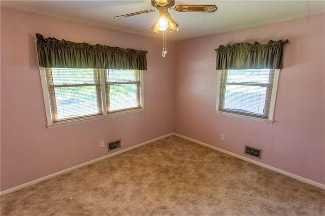 empty room with light colored carpet and ceiling fan