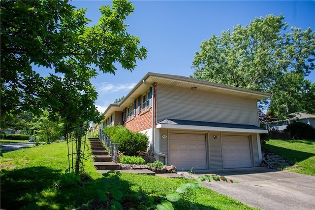 view of side of property with a garage and a yard