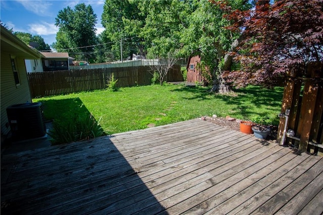 deck with a yard and central AC