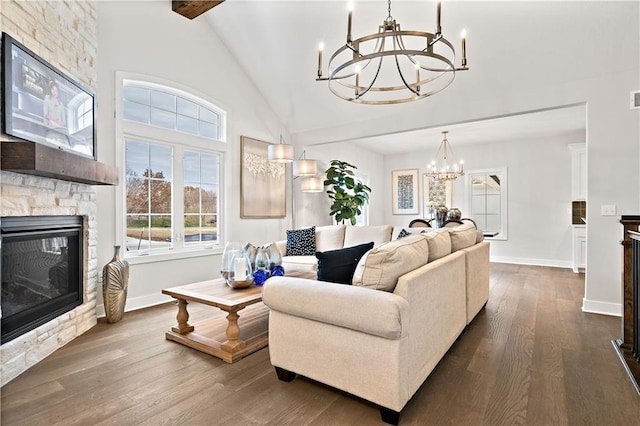 living room featuring beam ceiling, a chandelier, dark hardwood / wood-style flooring, a fireplace, and high vaulted ceiling