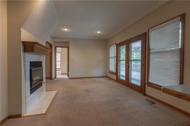 unfurnished living room with light carpet, crown molding, and a fireplace