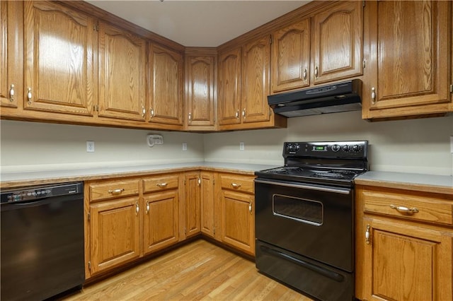 kitchen with black appliances and light wood-type flooring