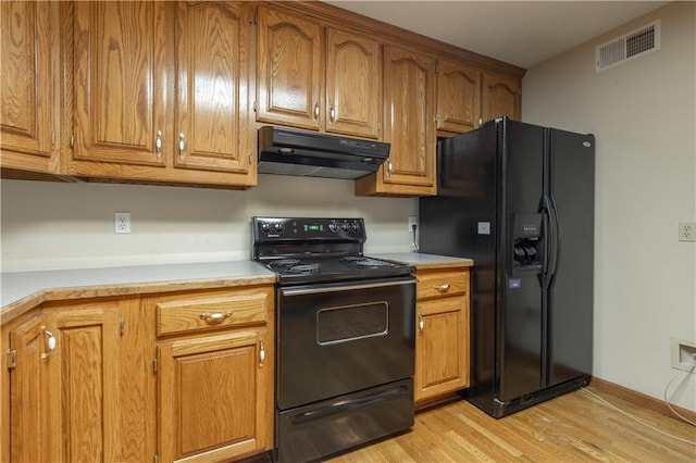 kitchen featuring black appliances and light wood-type flooring