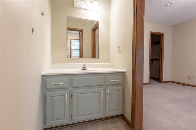 bathroom with vanity and a textured ceiling