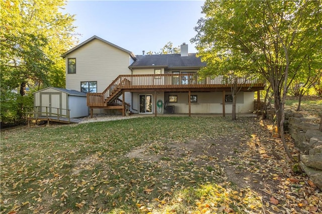 rear view of property with central air condition unit, a storage shed, a deck, and a lawn