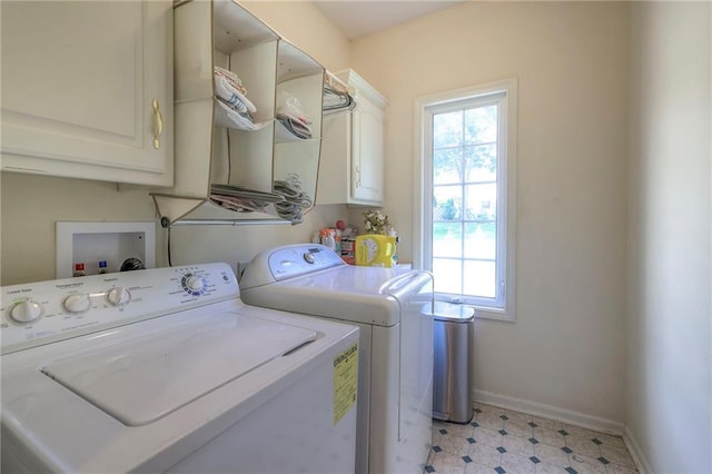 laundry area with cabinets and washing machine and clothes dryer