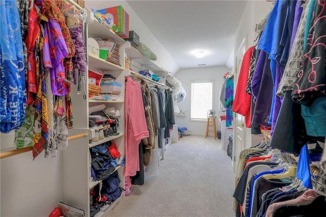 spacious closet featuring light carpet and lofted ceiling