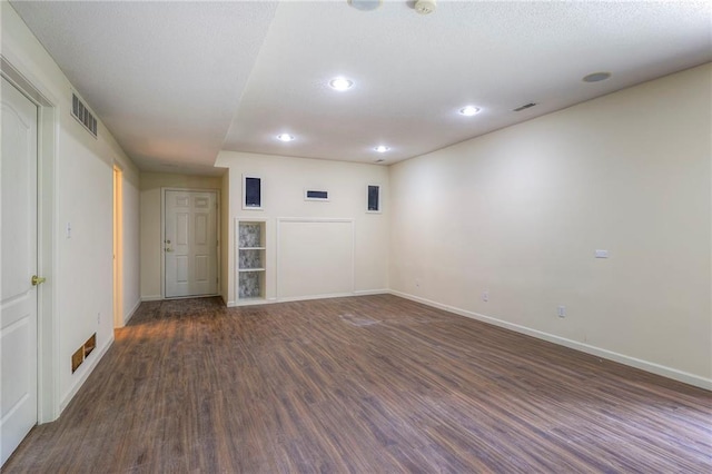 spare room featuring dark hardwood / wood-style flooring