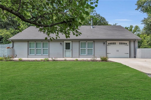 view of front of house with a front lawn, driveway, fence, roof with shingles, and a garage