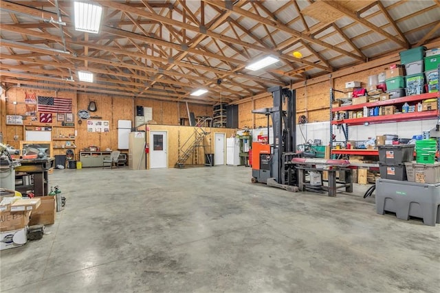 garage with a workshop area and metal wall