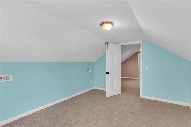 bonus room with vaulted ceiling, visible vents, baseboards, and carpet floors